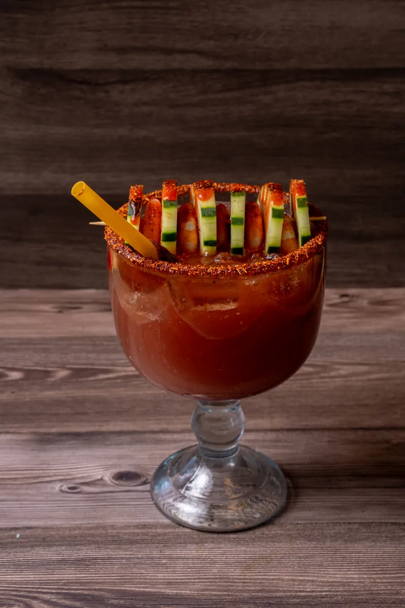 Michelada goblet rimmed with chili and cucumber