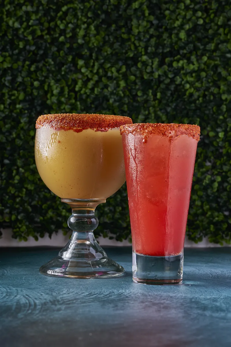 Mango and watermelon margaritas against the garden wall