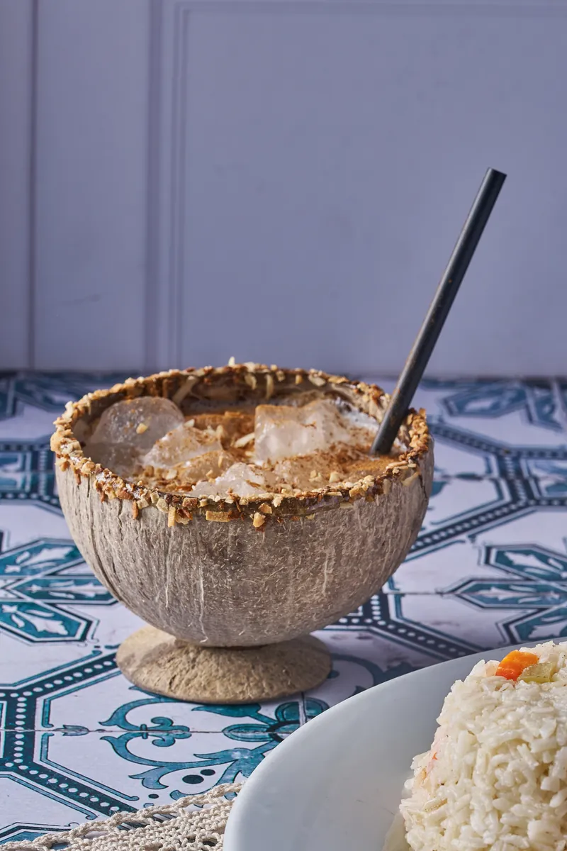 Cocktail served in a carved coconut