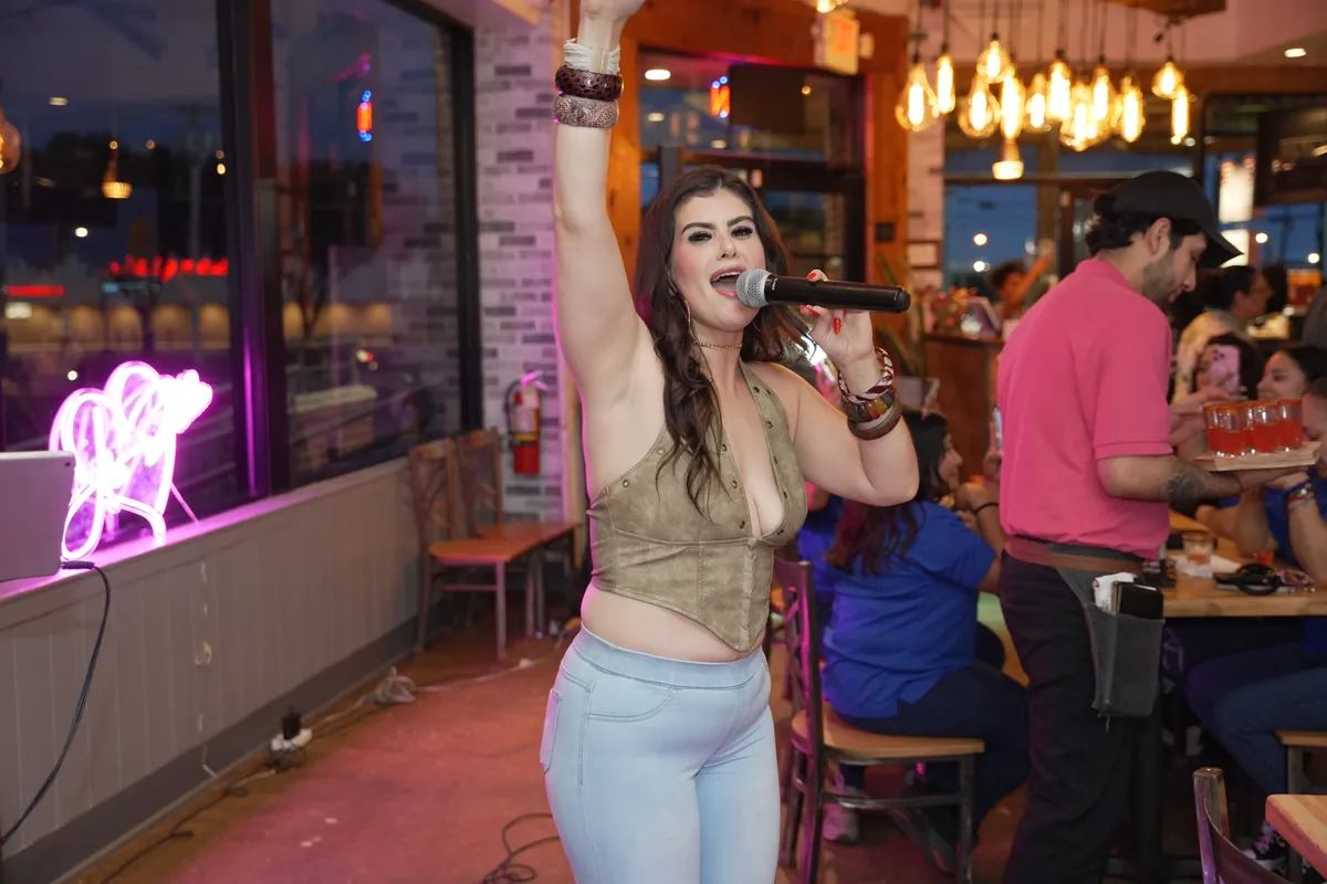 Guest singing karaoke under the neon lights