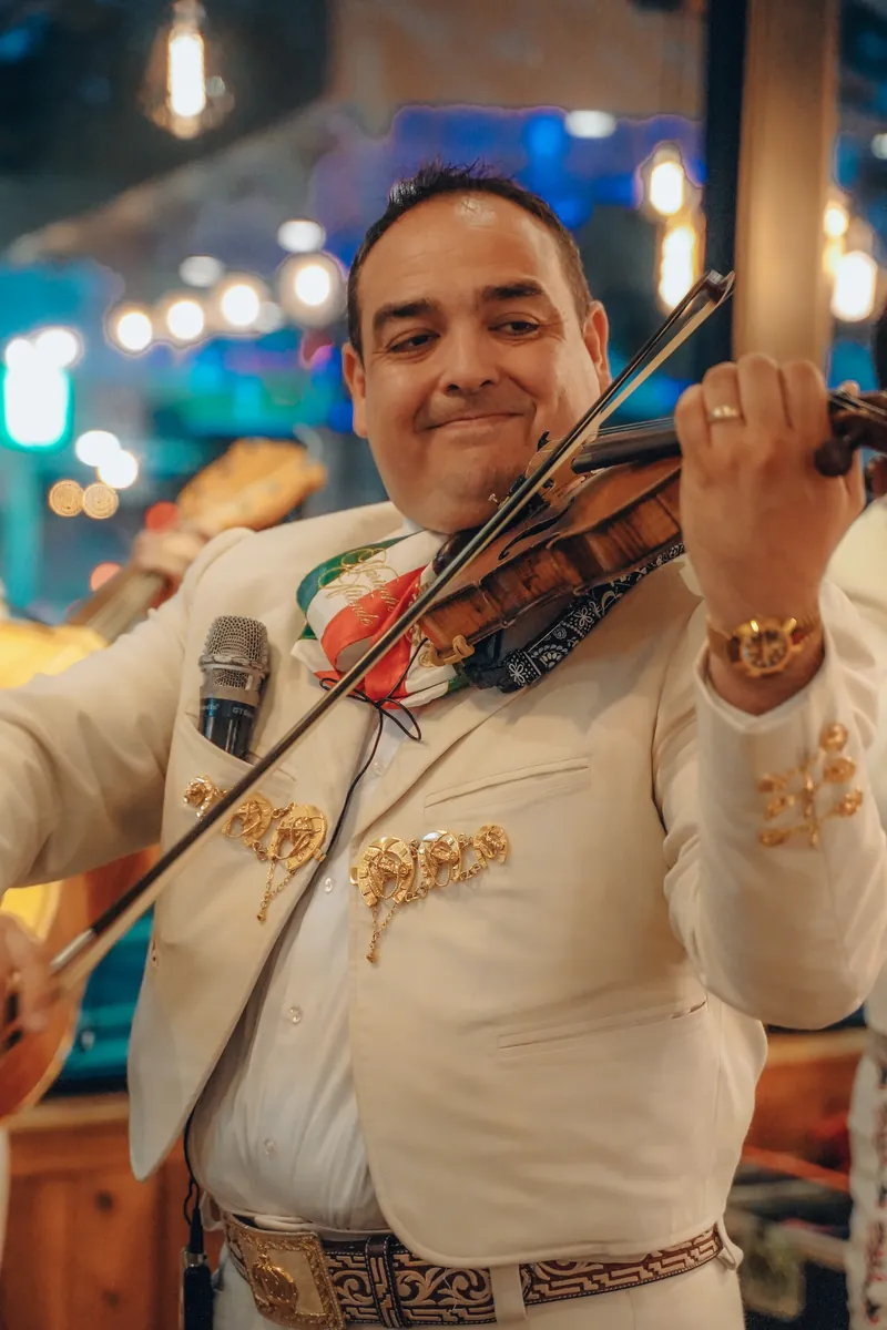 Mariachi violinist performing in the dining room