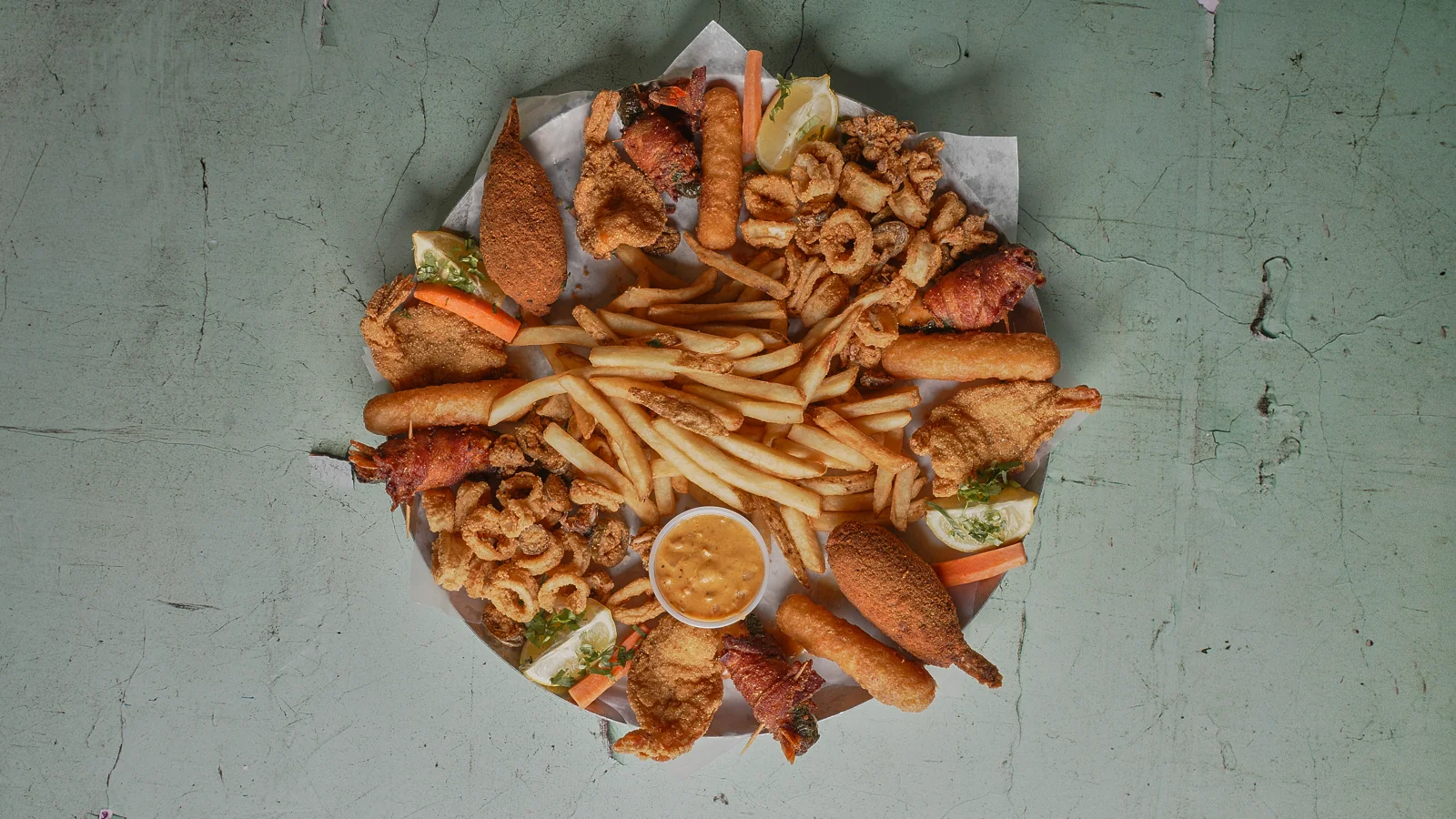 A generous spread of fried seafood, fries and dipping sauces